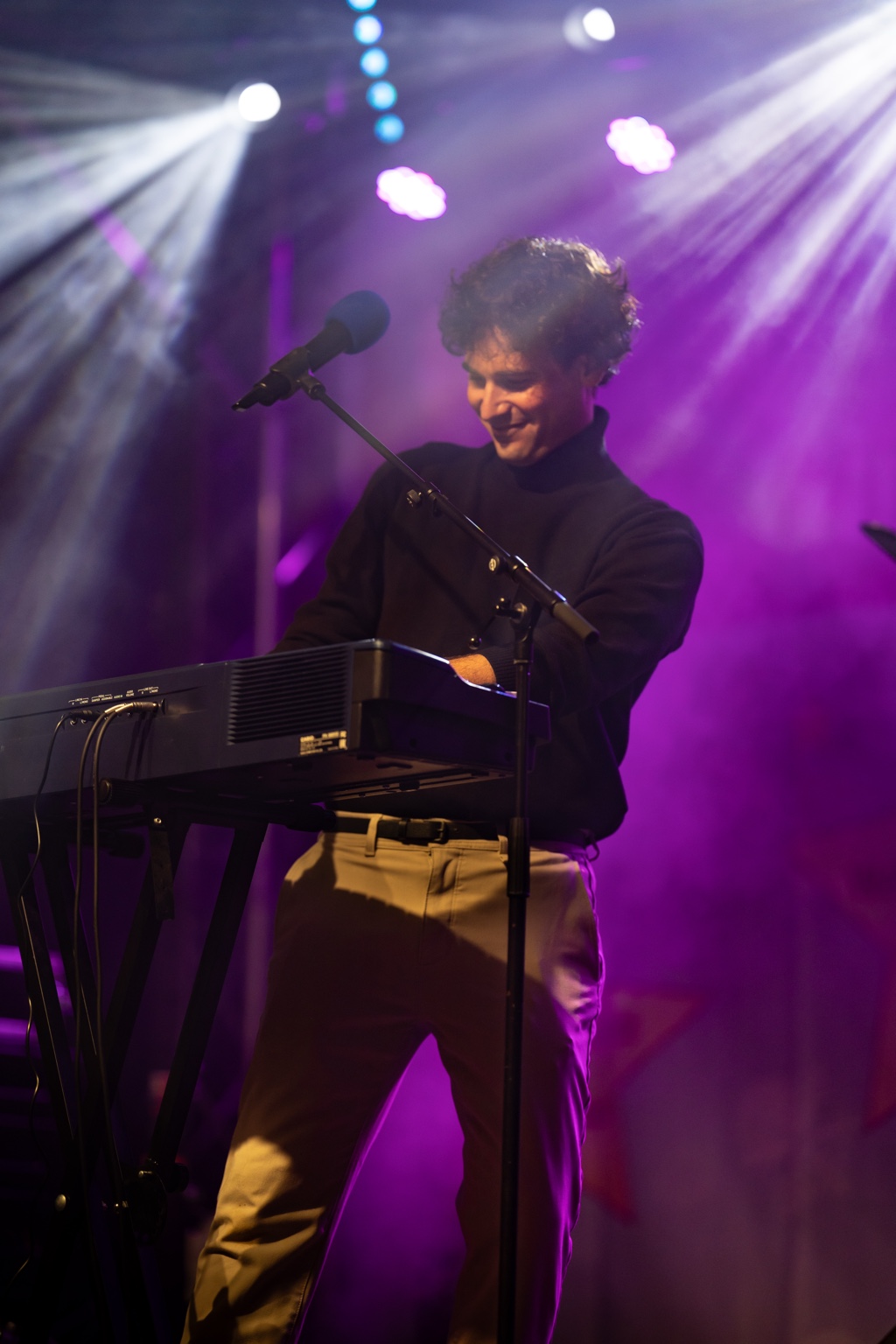 Salvatore De Concilis smiling while performing on stage